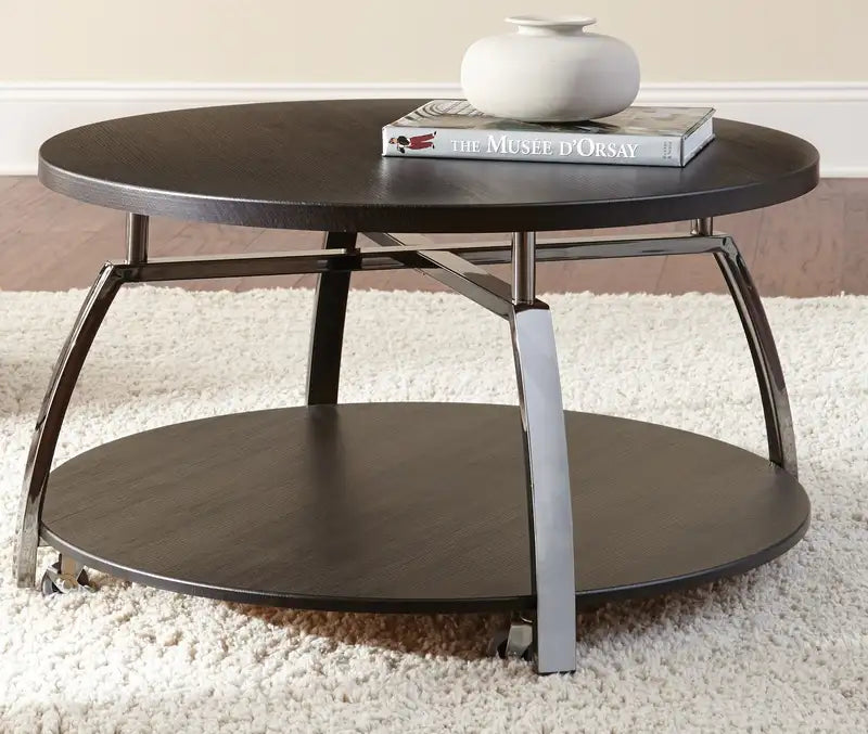 Elegant Cocktail Table: Soft Round Top, Black Nickel Base, Casters